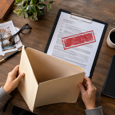 A beneficiary and attorney review life insurance records together in a bright New York office.
